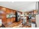 Bright kitchen features dark wood cabinets, stainless appliances, hardwood floors, and island cart at 9400 E Iliff Ave # 181, Denver, CO 80231