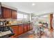 The kitchen is equipped with stainless steel appliances, dark wood cabinets and wood floors at 9400 E Iliff Ave # 181, Denver, CO 80231