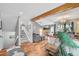 Open-concept living room with hardwood floors, fireplace, and stairs at 9400 E Iliff Ave # 181, Denver, CO 80231