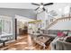 Spacious living room with hardwood floors and open floor plan to the dining area and view of the staircase at 9400 E Iliff Ave # 181, Denver, CO 80231