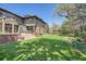 Spacious backyard with manicured lawn, stepped patio, and landscaped garden beds surrounding the property at 171 N Franklin St, Denver, CO 80218