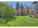 Lush backyard featuring a waterfall feature, manicured lawn, and mature trees providing privacy at 171 N Franklin St, Denver, CO 80218
