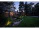 Stunning backyard featuring a pond with plants, trees, and green space enhanced by subtle landscape lighting at 171 N Franklin St, Denver, CO 80218