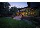Inviting backyard at twilight with patio, beautiful landscaping, and home exterior at 171 N Franklin St, Denver, CO 80218