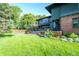 Expansive green backyard with lush lawn, a beautiful brick patio, and lovely landscaping at 171 N Franklin St, Denver, CO 80218