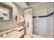 Bathroom features a white shower tub, toilet, vanity and a sink with floral patterned curtains at 171 N Franklin St, Denver, CO 80218