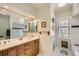Bathroom with a double sink vanity, a large mirror, and a walk-in shower, all with neutral toned walls at 171 N Franklin St, Denver, CO 80218