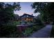 Gorgeous home surrounded by lush landscaping with a brick perimeter and plants at twilight at 171 N Franklin St, Denver, CO 80218