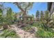 Stone-paved garden with a shaded pergola, brick accents, and mature landscaping in a serene setting at 171 N Franklin St, Denver, CO 80218
