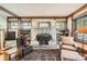 Cozy living room with stone fireplace, built-in bookshelves, and hardwood floors at 171 N Franklin St, Denver, CO 80218