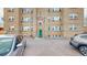 A view of the backyard, featuring a green door and available parking for residents and visitors alike at 505 N Logan St # 14, Denver, CO 80203