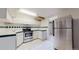 Classic kitchen features modern appliances, white cabinetry and tile flooring at 505 N Logan St # 14, Denver, CO 80203
