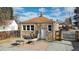 Stone home exterior featuring backyard patio with wooden fence and gravel at 1621 Trenton St, Denver, CO 80220