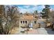 The home has a stone exterior, a small patio area, and a fenced-in backyard perfect for outdoor activities at 1621 Trenton St, Denver, CO 80220