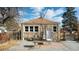 Cozy backyard of a stone home featuring a brick patio and gravel, enclosed by a wooden fence at 1621 Trenton St, Denver, CO 80220