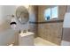Modern bathroom with updated fixtures, a sleek vanity, and stylish tile accents throughout at 1621 Trenton St, Denver, CO 80220