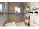 Tiled bathroom featuring a shower-tub combo, modern fixtures and stacked white towels at 1621 Trenton St, Denver, CO 80220