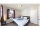 Cozy bedroom with a plush queen bed, soft carpet, and natural light from a window at 1621 Trenton St, Denver, CO 80220