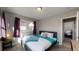 Relaxing bedroom with a comfortable bed and access to an adjoining room at 1621 Trenton St, Denver, CO 80220