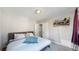 Cozy bedroom with carpet, closet and comfortable bed with throw blanket at 1621 Trenton St, Denver, CO 80220