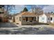 Charming home with a cozy front porch, stone exterior, and freshly graveled driveway at 1621 Trenton St, Denver, CO 80220