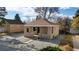 Charming home with a front yard, beautiful stonework, covered porch and fresh gravel at 1621 Trenton St, Denver, CO 80220
