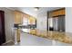 Bright kitchen featuring a breakfast bar, modern appliances, and stylish backsplash at 1621 Trenton St, Denver, CO 80220