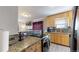 Well-appointed kitchen with stainless steel appliances, stylish granite countertops, and a mosaic backsplash at 1621 Trenton St, Denver, CO 80220