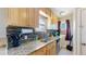 Well-lit kitchen with modern appliances, granite counters, wood cabinets, and stylish backsplash at 1621 Trenton St, Denver, CO 80220