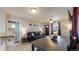Open-concept living room with wood floors, modern furniture, and seamless transition to the kitchen at 1621 Trenton St, Denver, CO 80220