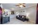 Inviting living room with gray walls, wood floors, comfortable seating, and a ceiling fan at 1621 Trenton St, Denver, CO 80220