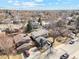 A high angle view of a charming neighborhood with mature trees and a house with a two-car garage and well-kept lawn at 6676 Zang St, Arvada, CO 80004