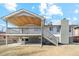 Exterior view of home with covered deck and stairs at 6676 Zang St, Arvada, CO 80004