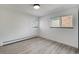 Empty bedroom with wood floors and light from two windows at 6676 Zang St, Arvada, CO 80004