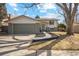 Charming home featuring an attached two-car garage, front lawn, and walkway to the front door at 6676 Zang St, Arvada, CO 80004