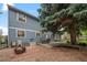 Large backyard featuring a patio, fire pit, mature trees, and ample space for outdoor entertaining at 9963 W Canyon Ave, Littleton, CO 80127