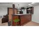Basement bar area with wood counter, shelves, tiled backsplash, small refrigerator and sink at 9963 W Canyon Ave, Littleton, CO 80127