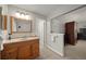 Bathroom featuring vanity with wood cabinets and a light wood trimmed mirror at 9963 W Canyon Ave, Littleton, CO 80127