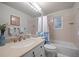 Bathroom featuring a tub with a shower curtain and vanity at 9963 W Canyon Ave, Littleton, CO 80127