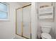 Bathroom featuring a toilet and shower/tub with gold sliding doors at 9963 W Canyon Ave, Littleton, CO 80127