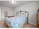 Bedroom featuring a bed, carpet, and a decorative iron headboard at 9963 W Canyon Ave, Littleton, CO 80127