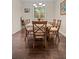 Open dining area with tile floors, stylish table and seating for six at 9963 W Canyon Ave, Littleton, CO 80127