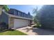 Spacious two-car garage with a paved driveway, and partial view of the two-story home at 9963 W Canyon Ave, Littleton, CO 80127