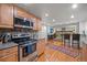 Modern kitchen with granite countertops, stainless steel appliances, and hardwood floors at 9963 W Canyon Ave, Littleton, CO 80127