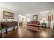 Cozy living room featuring hardwood floors, a leather sofa, and traditional furnishings at 9963 W Canyon Ave, Littleton, CO 80127
