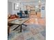 Bright living room with hardwood floors, bar seating, and a view to an open concept kitchen at 9963 W Canyon Ave, Littleton, CO 80127