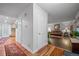 Hallway view leading to a living room featuring hardwood floors and a comfortable leather sofa at 9963 W Canyon Ave, Littleton, CO 80127