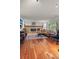 Inviting living room with hardwood floors, brick fireplace, and large windows at 9963 W Canyon Ave, Littleton, CO 80127