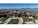 Stunning clubhouse with lush landscaping, flagpoles, and a lakeside view with mountain backdrop at 1898 Westport Ave, Berthoud, CO 80513
