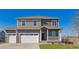 Charming two-story home boasts a three-car garage, covered porch, and inviting curb appeal at 1898 Westport Ave, Berthoud, CO 80513